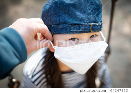 Child wearing a mask Child wearing a mask 64247533