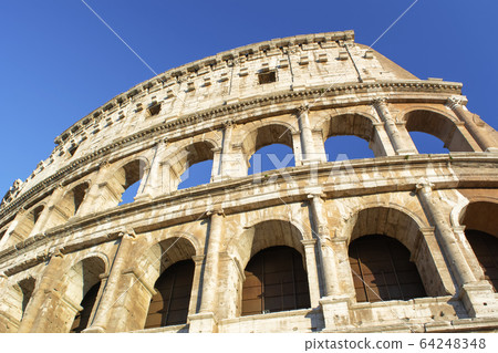 Part of Colosseum at blue sky in Rome, Italy, 64248348