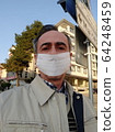 Closeup portrait of sad middle aged man in white surgical mask on the street. Pandemic coronavirus 2020. Quarantine.Virus concept. Epidemic infection 64248459