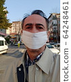 Portrait of bearded middle aged man in beige jacket and shirt outdoors. Covid-19 pandemic concept with copy space on the urban street. Man with protective face mask 64248461