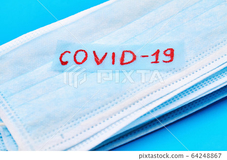 Stack of medical masks on the blue background with 64248867