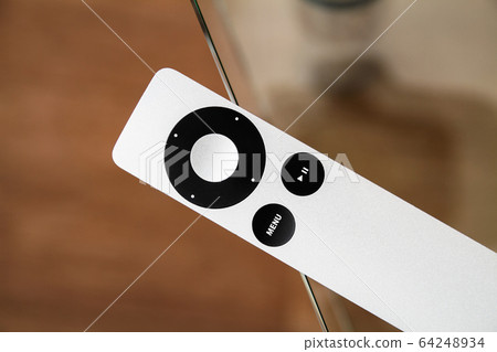 The modern grey steel Remote Control lies on a The modern grey steel Remote Control lies on a 64248934