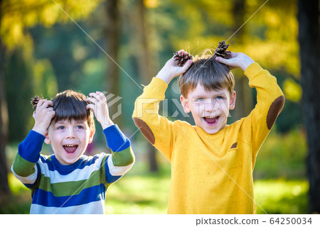 Two Cute sibling little boy playing together with 64250034