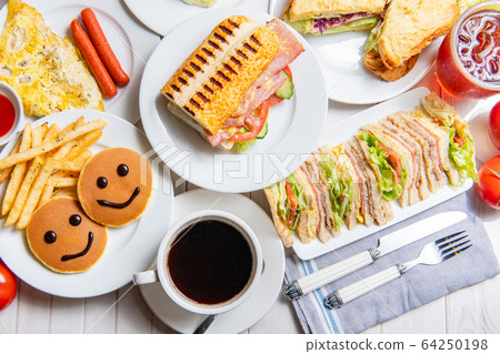 Breakfast, sandwiches, burgers, pancakes, eggs, vegetables, coffee, dining table Breakfast, sandwiches, burgers, pancakes, eggs, vegetables, coffee, dining table 64250198