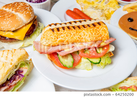Breakfast, sandwiches, burgers, pancakes, eggs, vegetables, coffee, dining table Breakfast, sandwiches, burgers, pancakes, eggs, vegetables, coffee, dining table 64250200