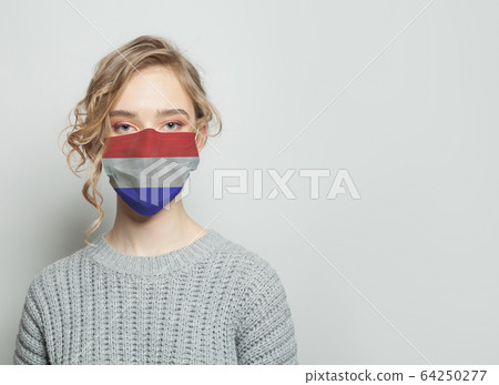 Young woman wearing a face mask with flag.  64250277