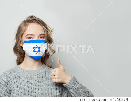 Happy woman in face mask holding thumb up Happy woman in face mask holding thumb up 64250279