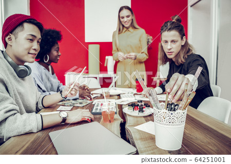 Cheerful mixed raced company visiting art workshop 64251001
