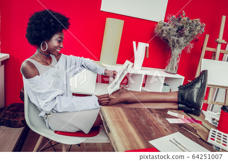 Amazing international designer looking at her sketch Amazing international designer looking at her sketch 64251007