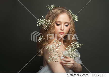 Pretty woman with long healthy curly hair. 64251056