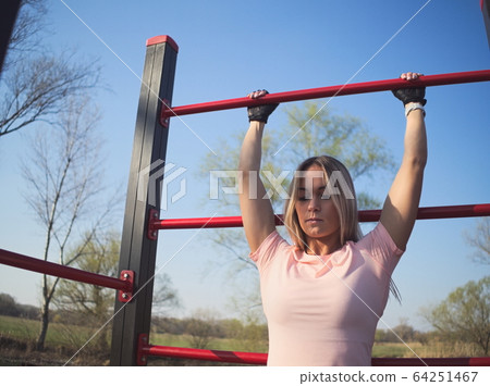 Woman Exercising in the Park 64251467