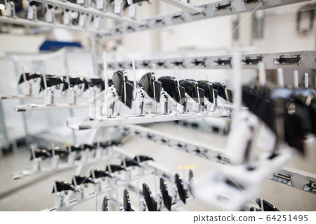 Freshly molded plastic moldings in automotive smart factory, industrial concept 64251495