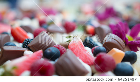 Close up of fruity chocolate cake with kind of fresh fruit and chocolate, food concept 64251497