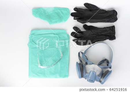 Twin filter half face respirator mask, plastic protective eyglasses, protective gown, cap, pair of gloves,  personal protective equipment to protect against the virus covid-19. 64251916