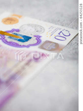 Twenty pounds banknote close up on light Twenty pounds banknote close up on light 64253128