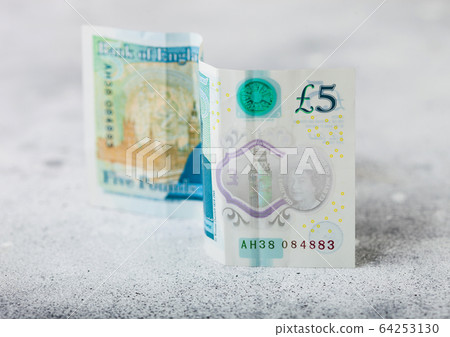 Five pounds banknote on light background. Economy 64253130
