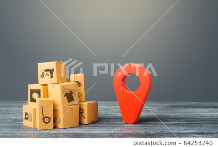 Red location pointer geolocation symbol and cardboard boxes. Global market and business, import and export. Distribution delivery of goods, freight transportation shipment. Logistics and warehousing. 64253240