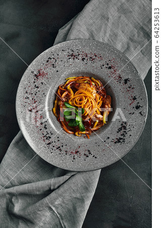 Spaghetti with vegetables tomato sauce and meat. Traditional italian food. Food photo. Dish from the chef. Beautiful feed, close-up shot, top view, copy space 64253613