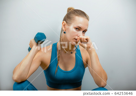 Fitness woman exercising with dumbbells. Beautiful fitness