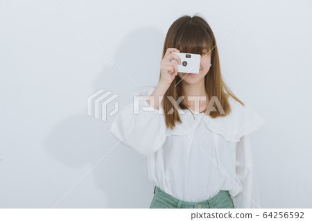 Portrait of asian woman using a vintage camera, side view, Free from copy space. Photography in action. Portrait of asian woman using a vintage camera, side view, Free from copy space. Photography in action. 64256592