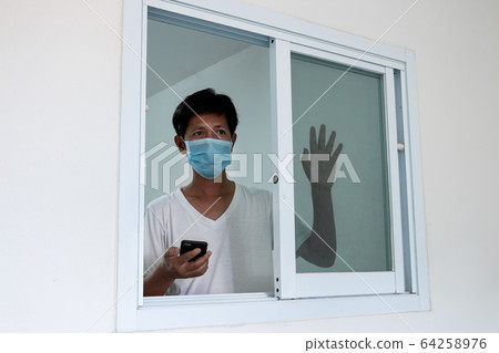 Man in isolation at home for coronavirus outbreak Man in isolation at home for coronavirus outbreak 64258976