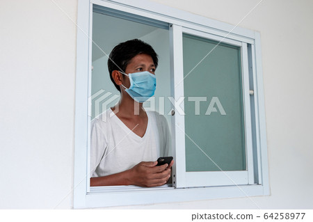 Man in isolation at home for coronavirus outbreak Man in isolation at home for coronavirus outbreak 64258977