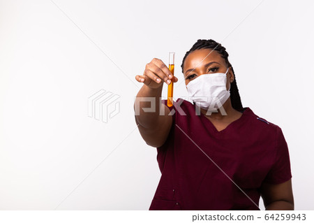 Covid-19, Vaccine development , outbreak and medicine concept - Doctor in medical protective mask holding a test tube on white background with copy space. Covid-19, Vaccine development , outbreak and medicine concept - Doctor in medical protective mask holding a test tube on white background with copy space. 64259943