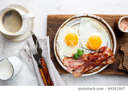 Fried eggs and bacon Fried eggs and bacon 64261867