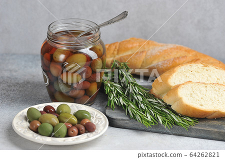 olives in a plate, baguette and olives olives in a plate, baguette and olives 64262821
