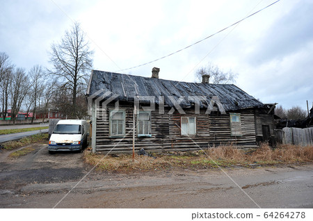 old wooden dilapidated house and an old car on the old wooden dilapidated house and an old car on the 64264278