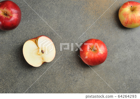 apples whole and cut on a gray background 64264293