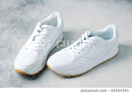 pair of white athletic sneakers 64264365