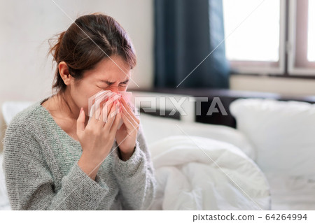 Sick asian woman have hight fever flu and sneezing Sick asian woman have hight fever flu and sneezing 64264994