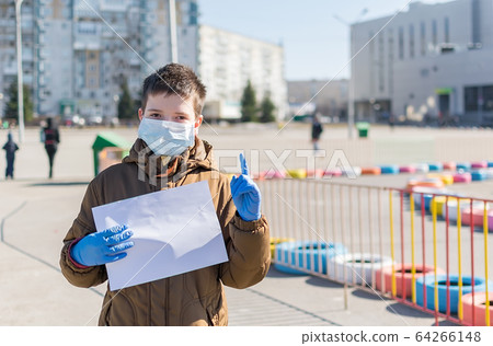 the child in the medical mask held up a warning finger the child in the medical mask held up a warning finger 64266148
