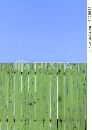 Blue sky and green old plank fence. Background material Blue sky and green old plank fence. Background material 64266554
