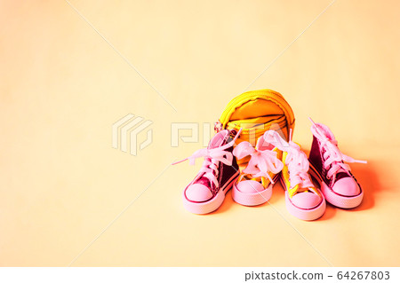 Sneakers and backpack isolated on color background Sneakers and backpack isolated on color background 64267803