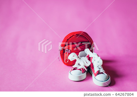 Sneakers and backpack isolated on color background Sneakers and backpack isolated on color background 64267804