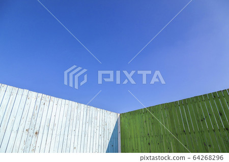 Corner of an old wooden fence painted blue and green. Background material Corner of an old wooden fence painted blue and green. Background material 64268296
