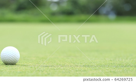 Golf ball image bokeh on green 64269725