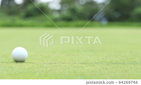 Golf ball image bokeh on green 64269748