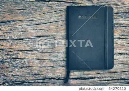 Bible on old wooden table with copy space for background. Concept for faith, spirituality and religion. Peace, hope, dreams concept Bible on old wooden table with copy space for background. Concept for faith, spirituality and religion. Peace, hope, dreams concept 64270810