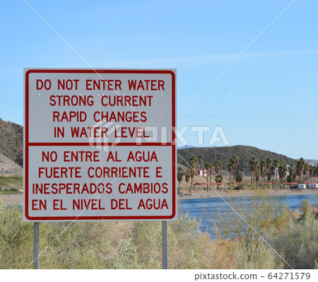 Rapid Changes in Water Level and Do Not Enter the Water sign overlooking the Colorado River in Laughlin, Clark County, Nevada USA 64271579