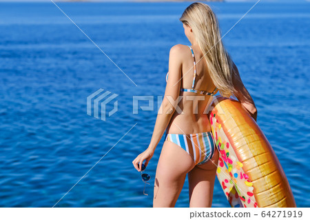 A beautiful blonde girl relaxing in the croatian A beautiful blonde girl relaxing in the croatian 64271919