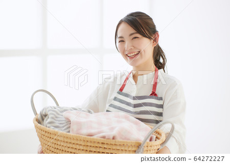 Young woman lifestyle apron washing 64272227