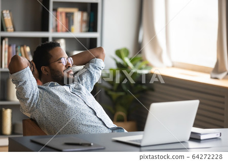African american freelance man in glasses chilling on cozy chair. 64272228