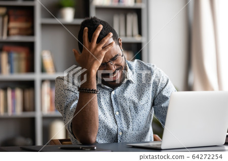 Stressed young african american man touching forehead, suffering from headache. 64272254