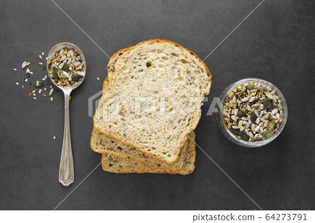Healthy bread slices on dark background with mix of seeds. 64273791