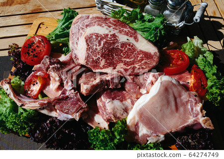A plate of marble beef with vegetables A plate of marble beef with vegetables 64274749