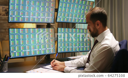 Businessman in suits looking at graphs Businessman in suits looking at graphs 64275108