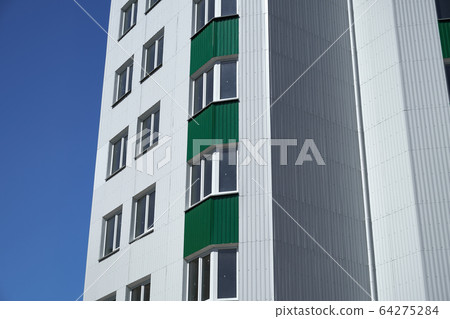 facade of a new multistory building with white and 64275284